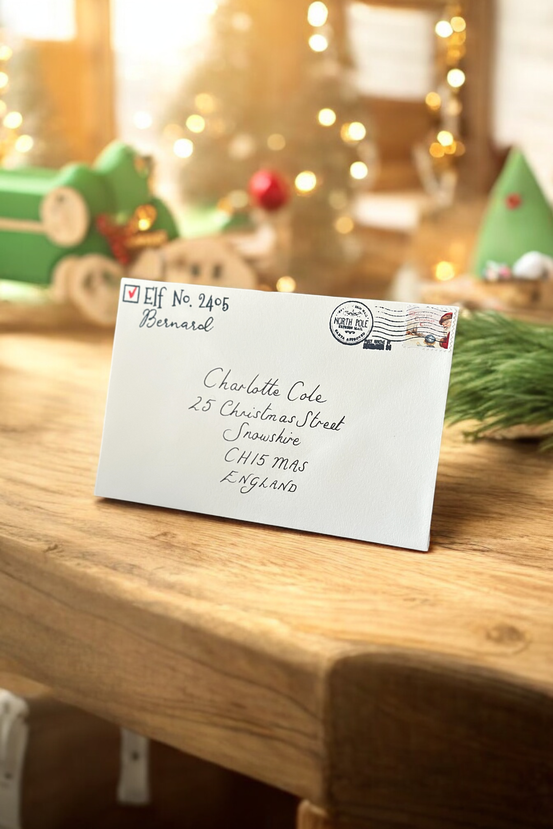 Luxury handwritten Santa letter and envelope with Polaroid photos beside Christmas tree