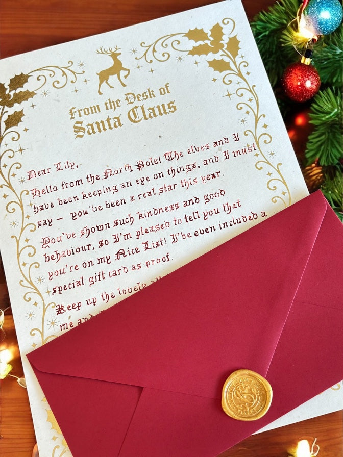 Personalised handwritten Santa letter and red envelope sealed with gold wax from Lapland