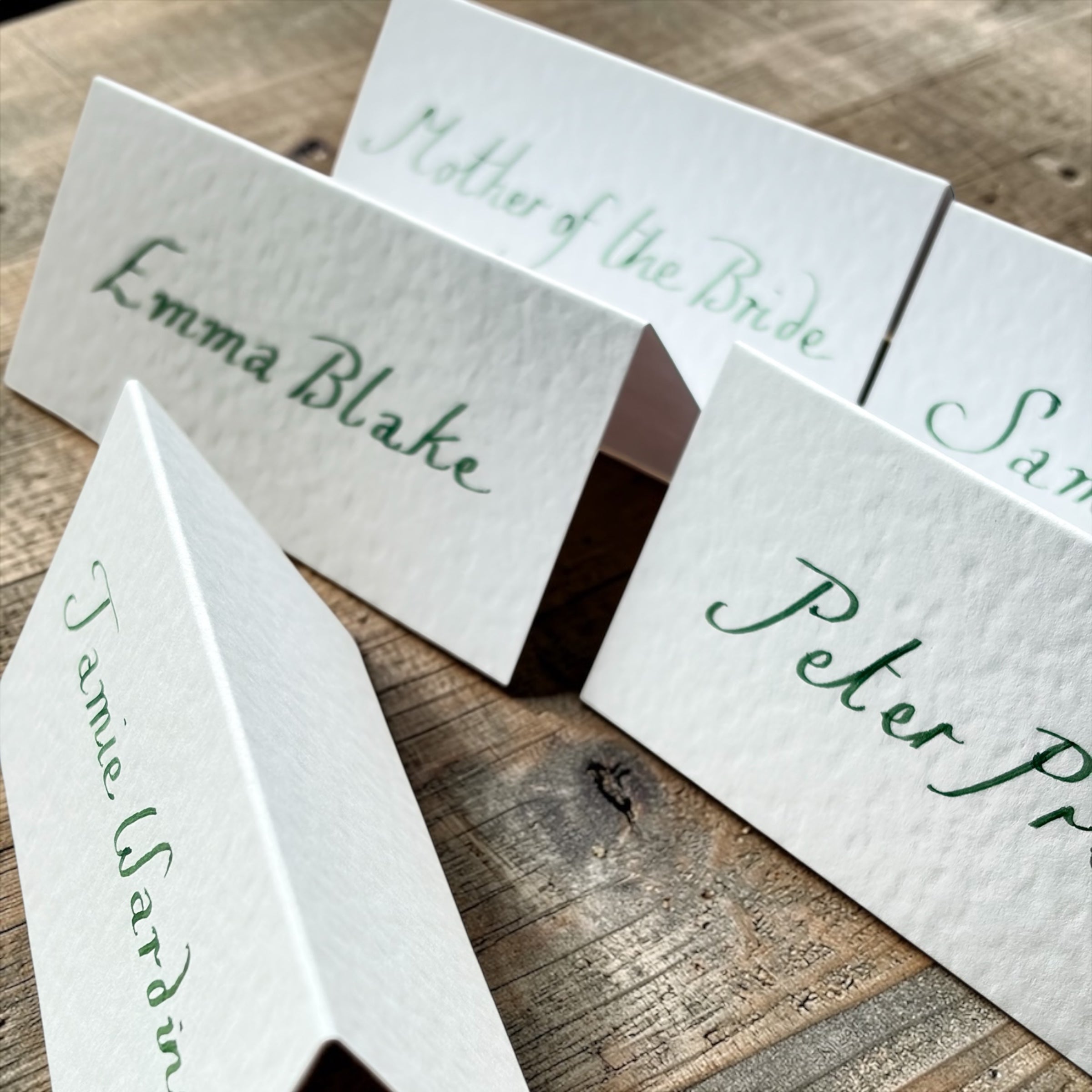 Handwritten White Wedding Place Cards: Emerald Green Ink Cursive