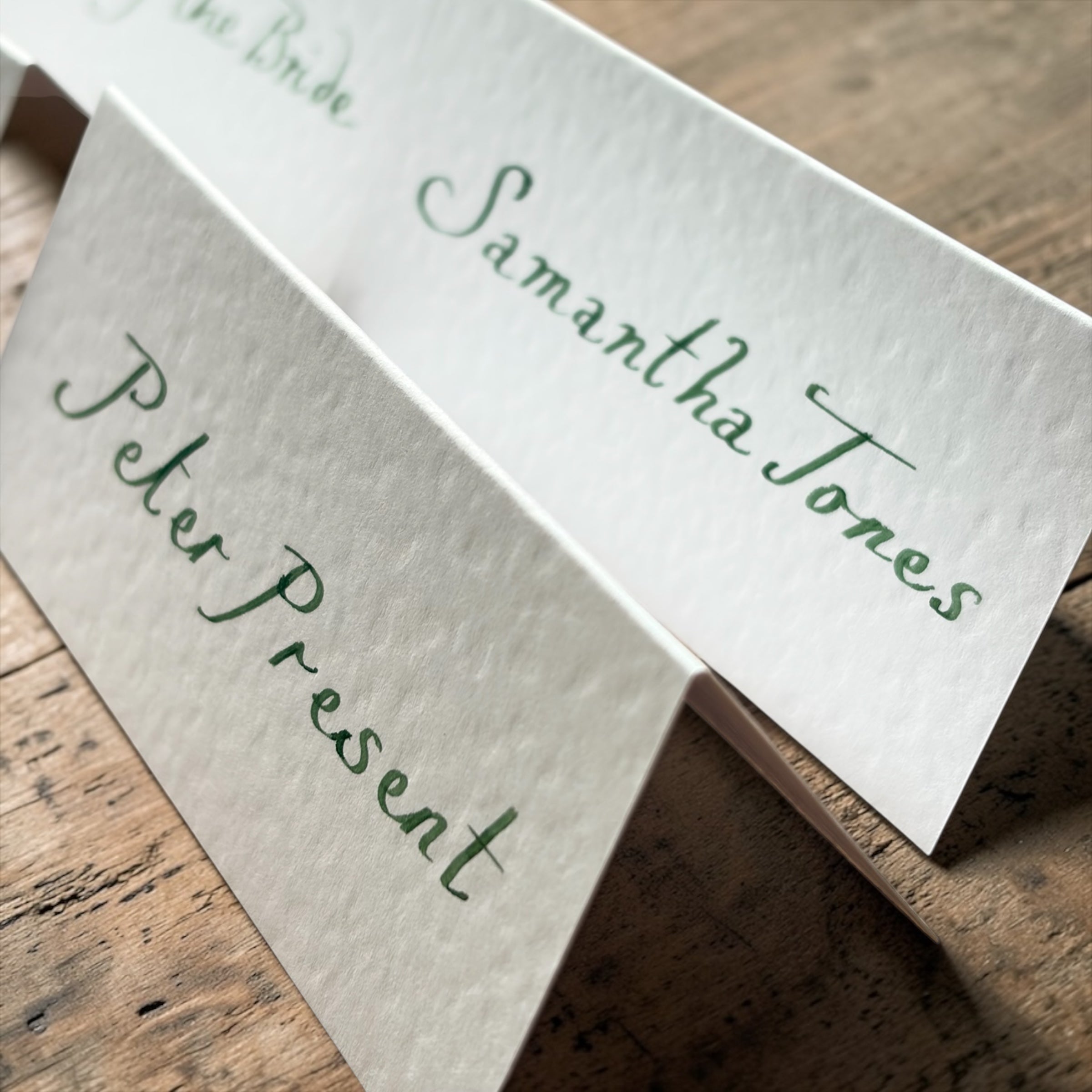 Handwritten White Wedding Place Cards: Emerald Green Ink Cursive