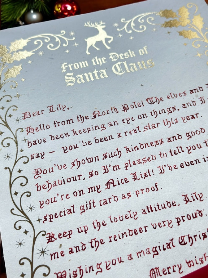 Handwritten Father Christmas letter with gold foil border and festive script